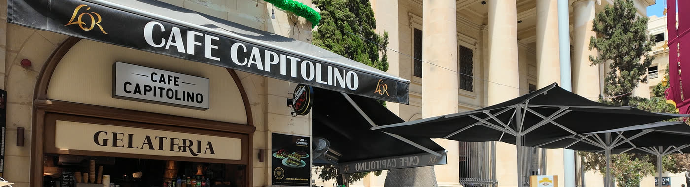 Café Capitolino awning and Gelateria sign beneath the Law Courts columns