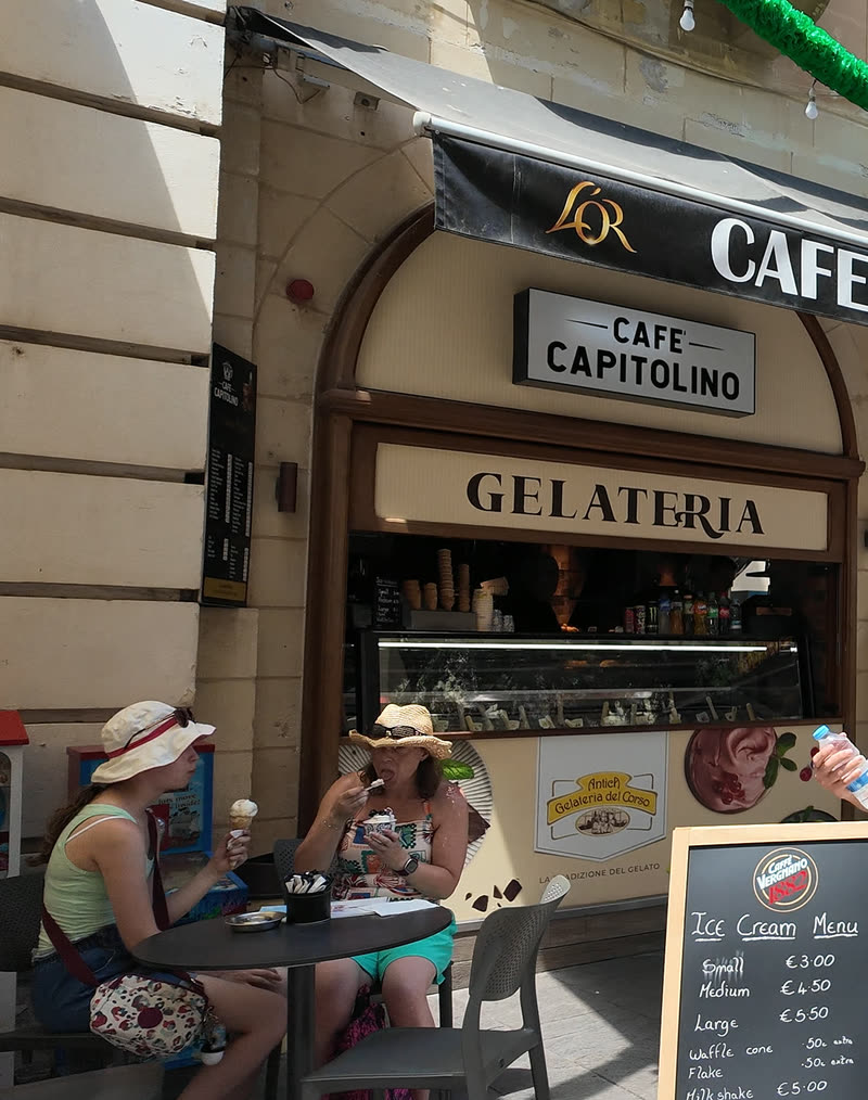Gelato at a terrace table under the Café Capitolino and Gelateria signs